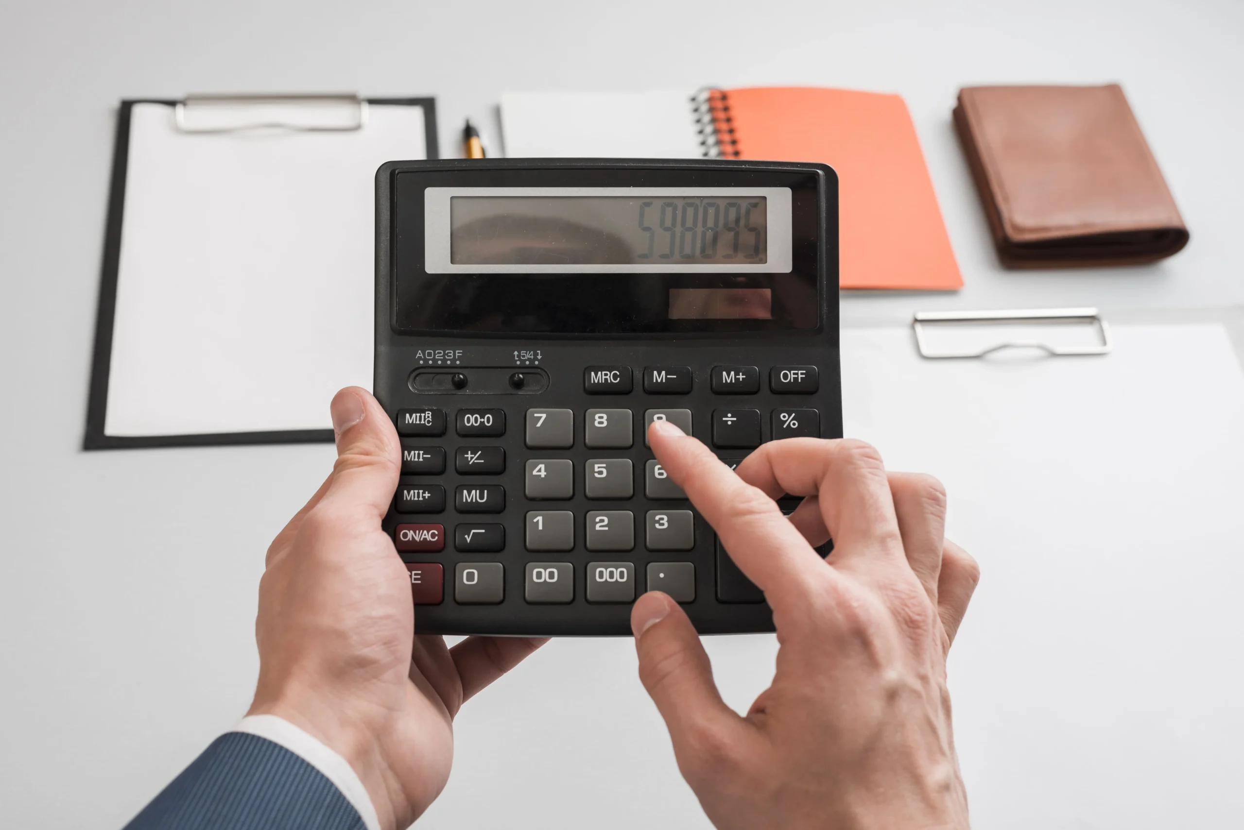 business-concept-with-hands-using-calculator